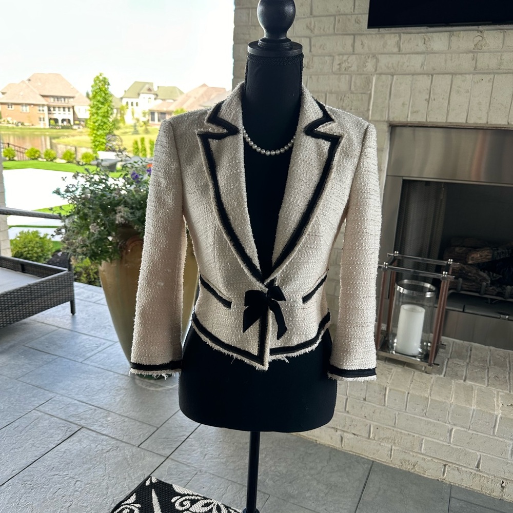 Bebe Jacket Creme with black trip/bow, 95% polyester 5% spandex